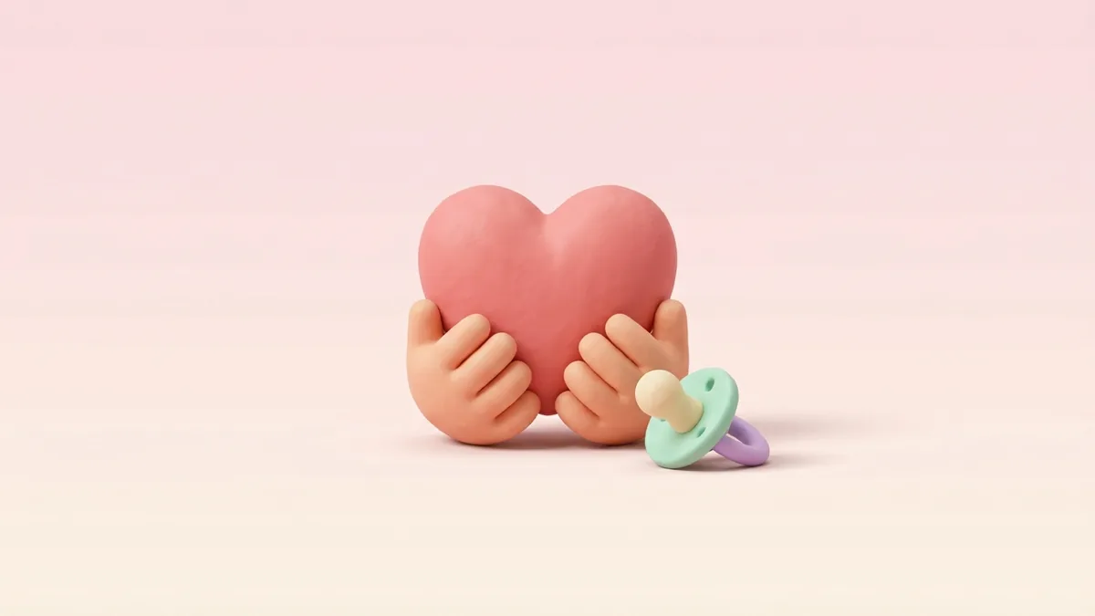 A 3D clay heart cradled in two hands with a pacifier on a soft pink background